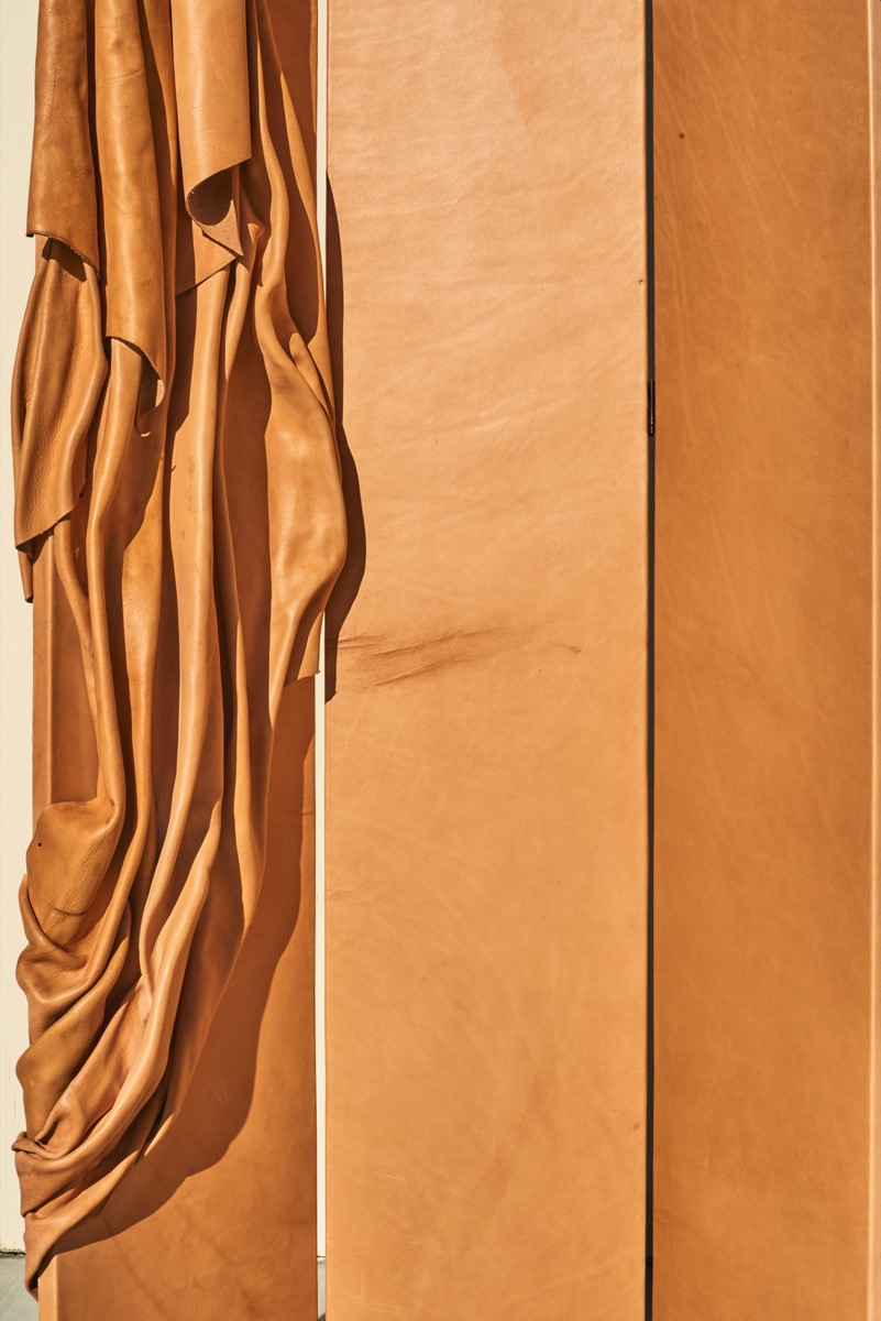 Progressive leather art mirror with vanitas elements for avant-garde design