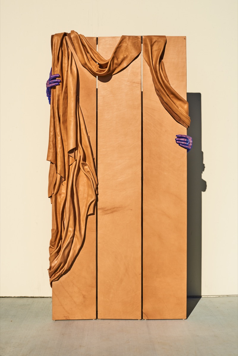 Leather art mirror showcasing vanitas themes