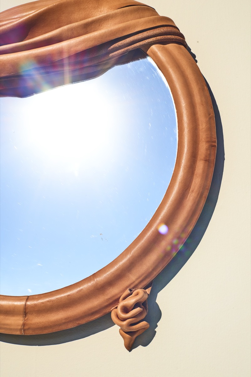 Handcrafted leather mirror with medieval inspiration